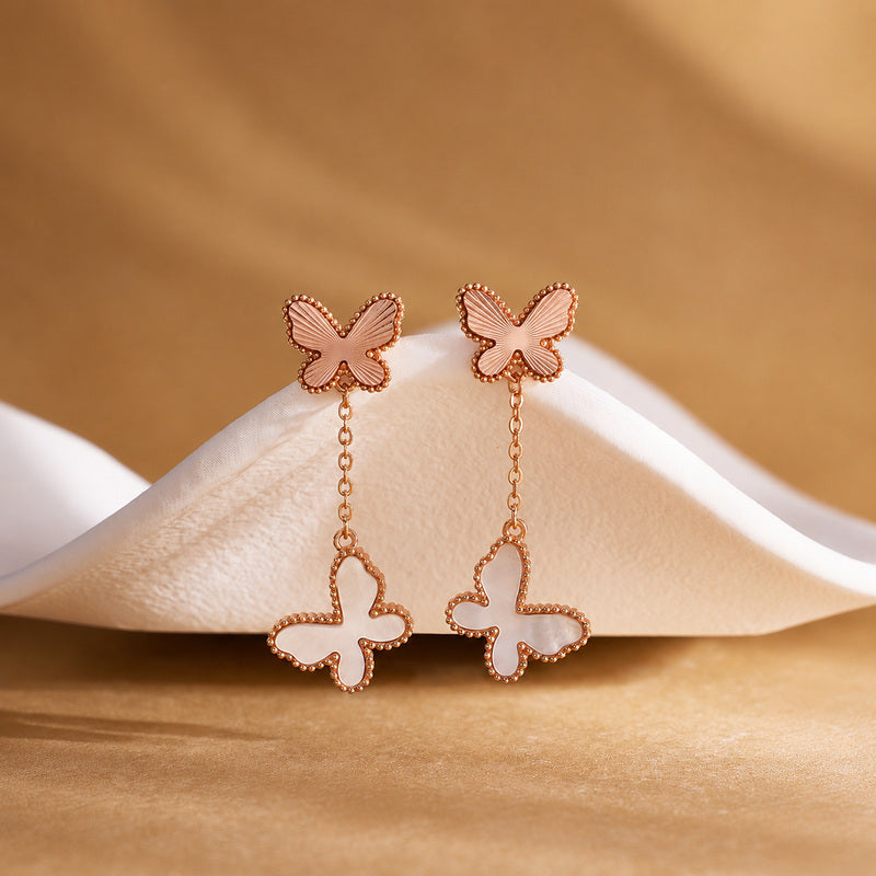 White mother-of-pearl butterfly drop earrings front view