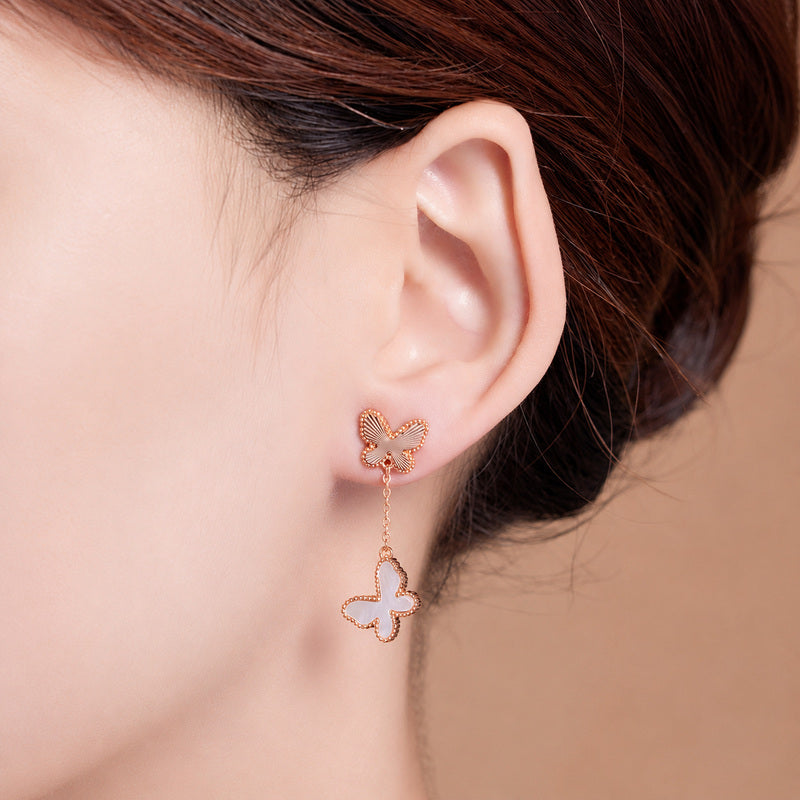 Model wearing white mother-of-pearl butterfly drop earring