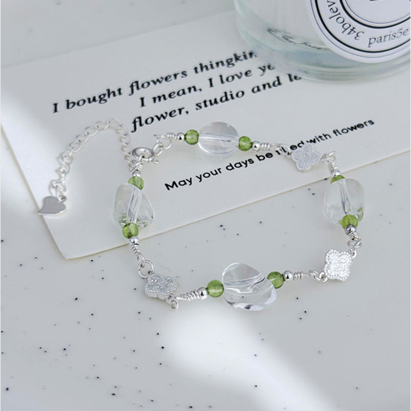 Clover bracelet with clear quartz beads in styled front view