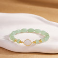 White shell fan nephrite jade bracelet on warm display