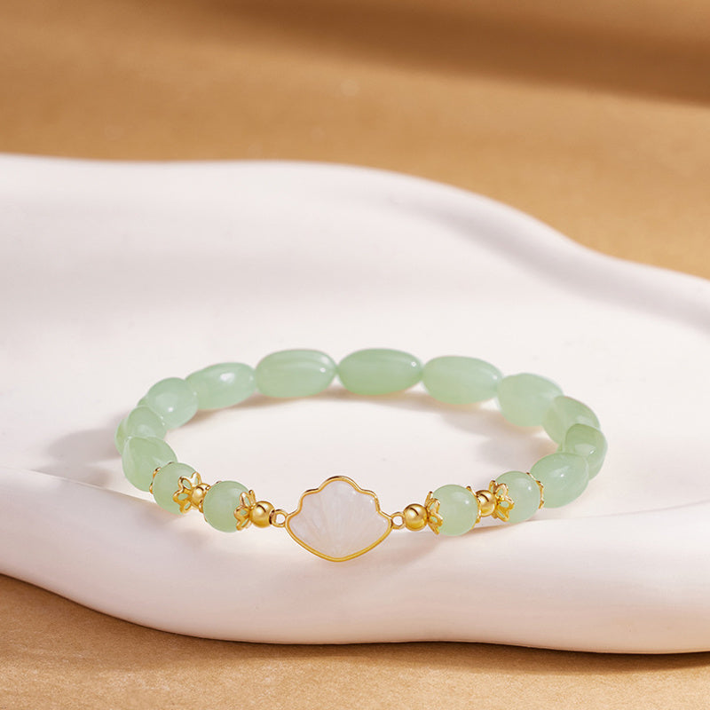 White shell fan nephrite jade bracelet on warm display