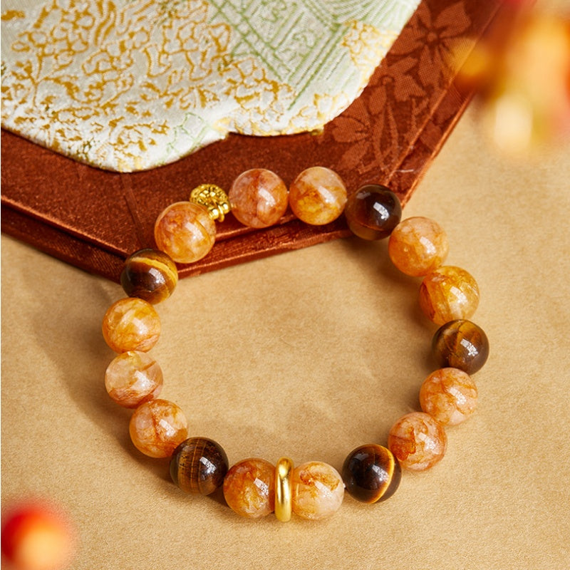 Overhead view showing the quartz bracelet and small gold fortune bag
