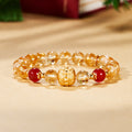 Yellow tower quartz bracelet with red agate and a gold-tone lotus centerpiece