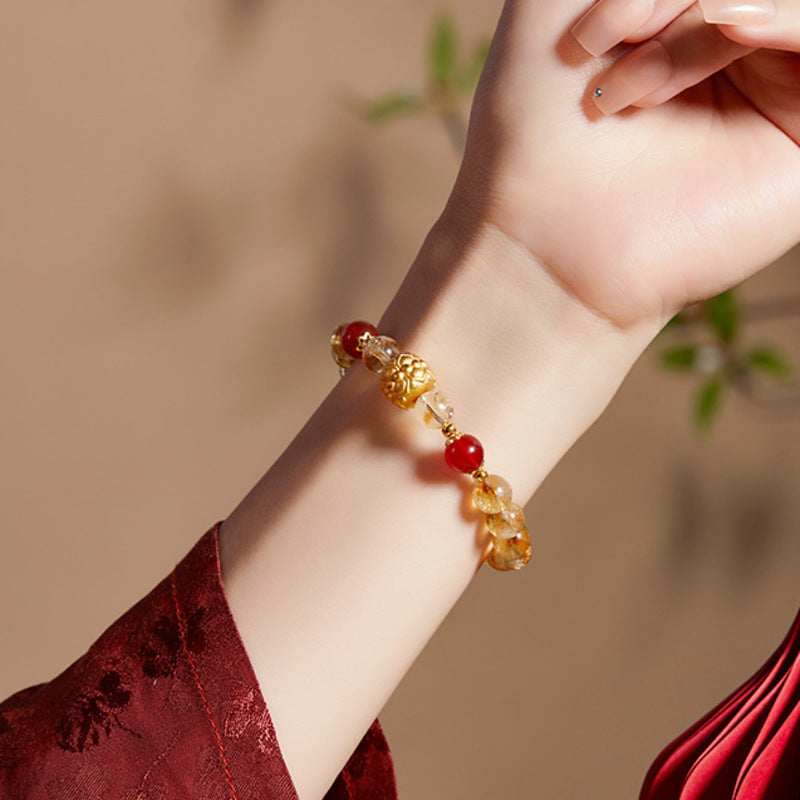 Supplier wrist photograph showing the lotus bracelet with red sleeve