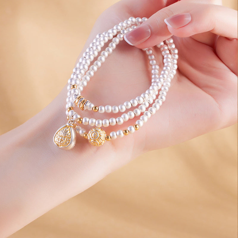 Hand holding the 999 silver triple-wrap deity bracelet