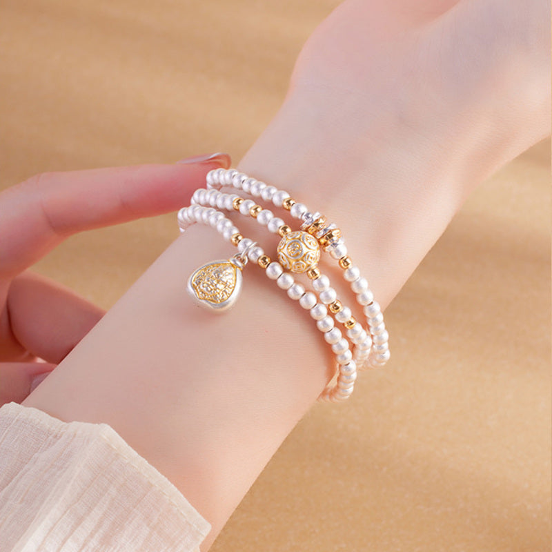 Close view of Yellow Wealth Deity bracelet on wrist