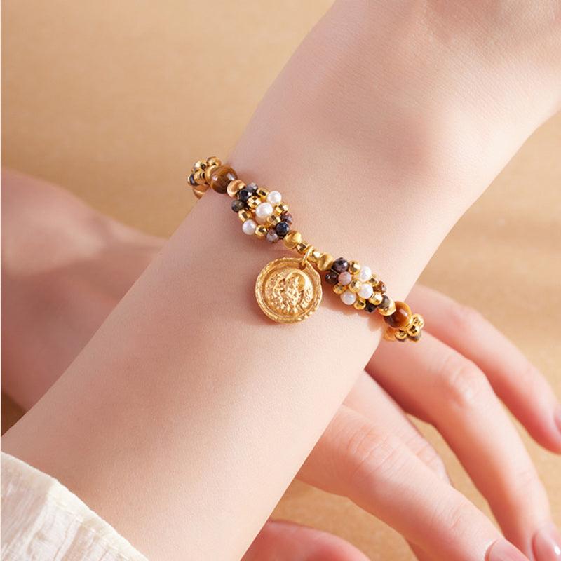 Yellow Wealth Deity pietersite pearl bracelet worn on the wrist