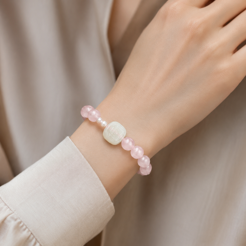 Woman wearing white jade Zaki Lhamo rose quartz bracelet