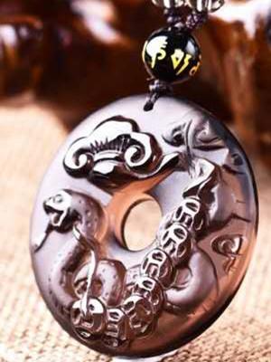 Round ice obsidian Snake zodiac pendant close-up