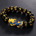 Black obsidian Pixiu bracelet on dark display