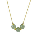 Pale green Hetian jade trio necklace with gold-tone chain displayed against a white background
